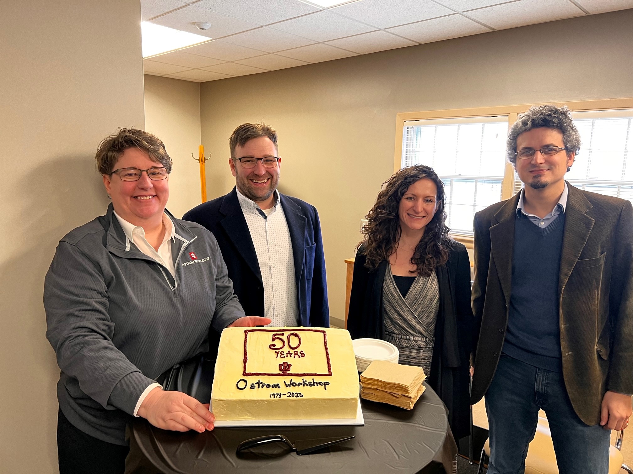 Ostrom Workshop Directors Angie Raymond, James Farmer, Jess Steinberg, and Gustavo Torrens celebrate in January 2023.